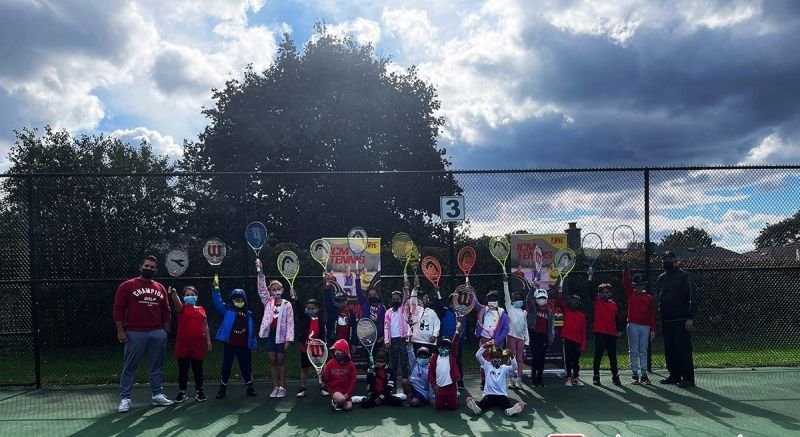 ICM players holding up their racquets on an outdoor court in Oshawa.