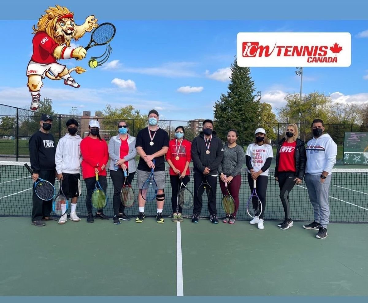 Adult players with medals on an outdoor court, with the ICM lion and logo added to the photo.